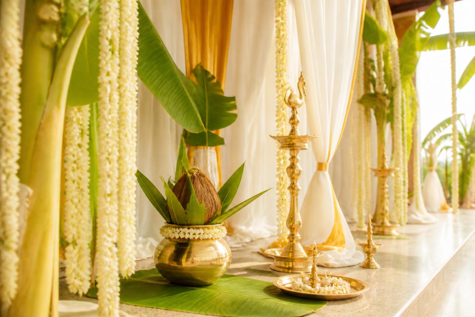 Brass lamps, kalash and jasmine strings arranged for a bright morning ceremony