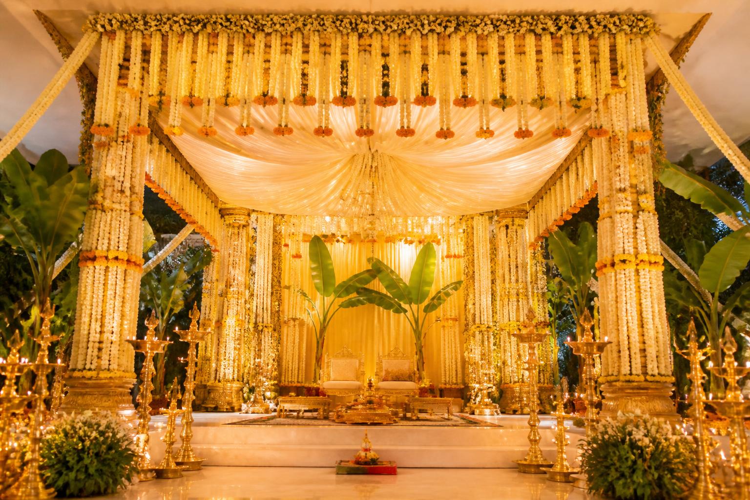A grand South Indian mandap of jasmine garlands and glowing brass lamps